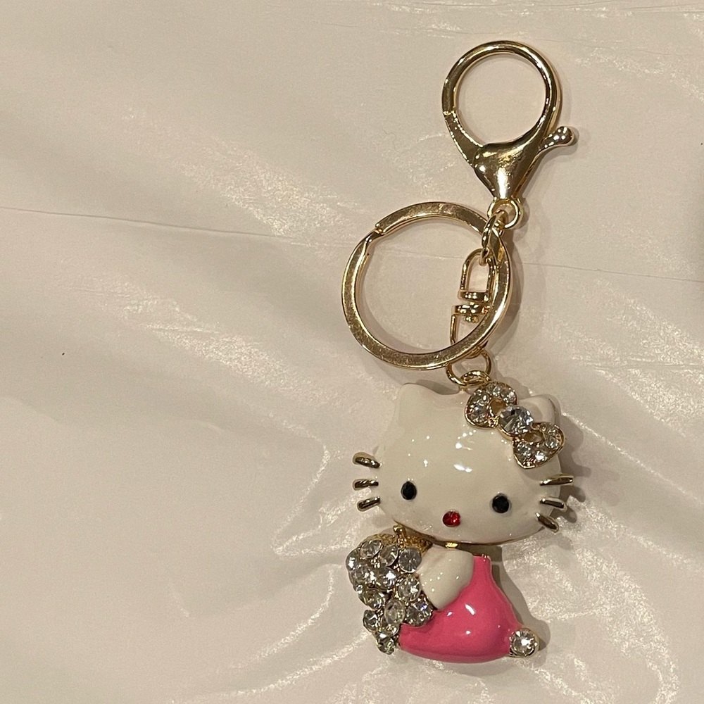 Hello kitty holding a Bouquet of Crystal flowers keychain.NWT